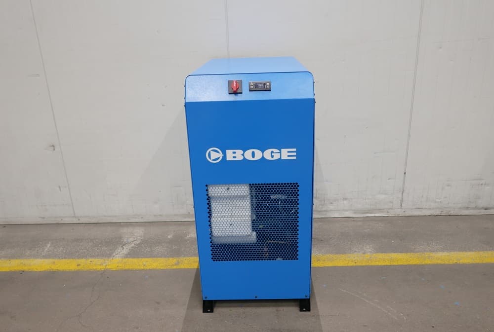 A blue BOGE air dryer unit stands against a plain wall, featuring a control panel and ventilation grille.