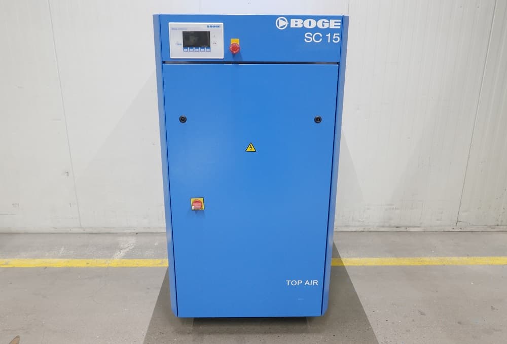 Blue BOGE SC 15 air compressor in an industrial setting, featuring control panel and safety symbols.