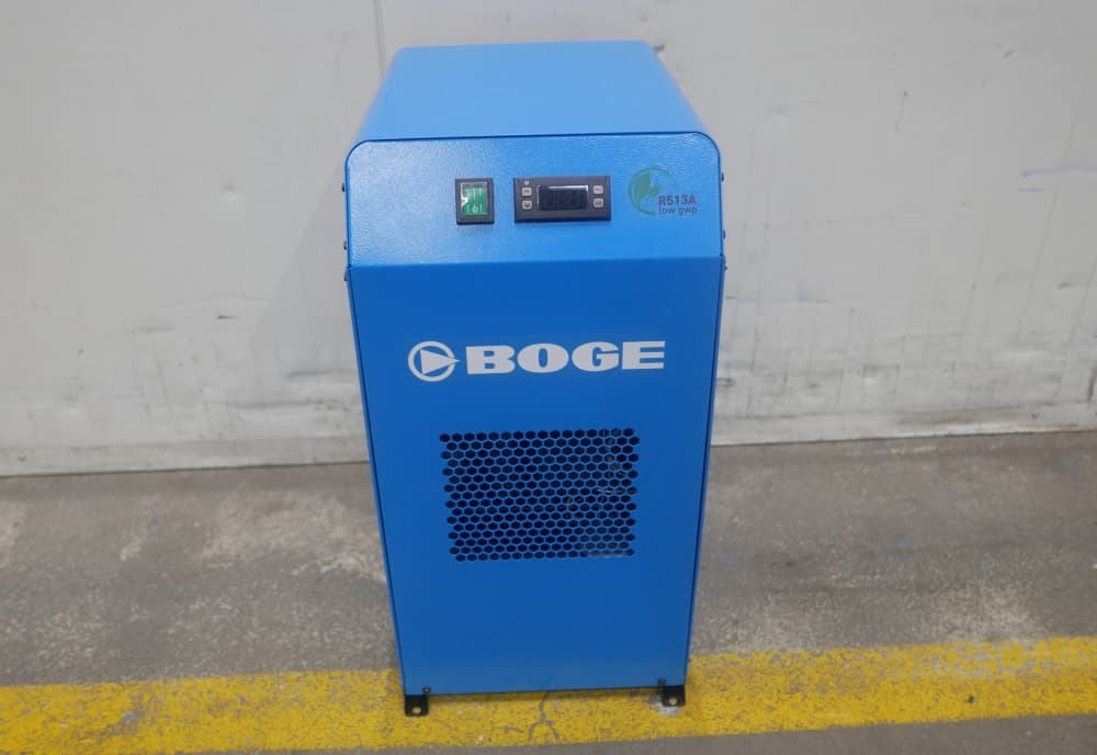 BOGE blue air dryer unit with digital display and green power button, placed on a concrete floor.