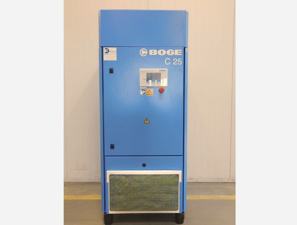 BOGE C 25 air compressor in blue, featuring a control panel and safety labels, standing in an industrial setting.