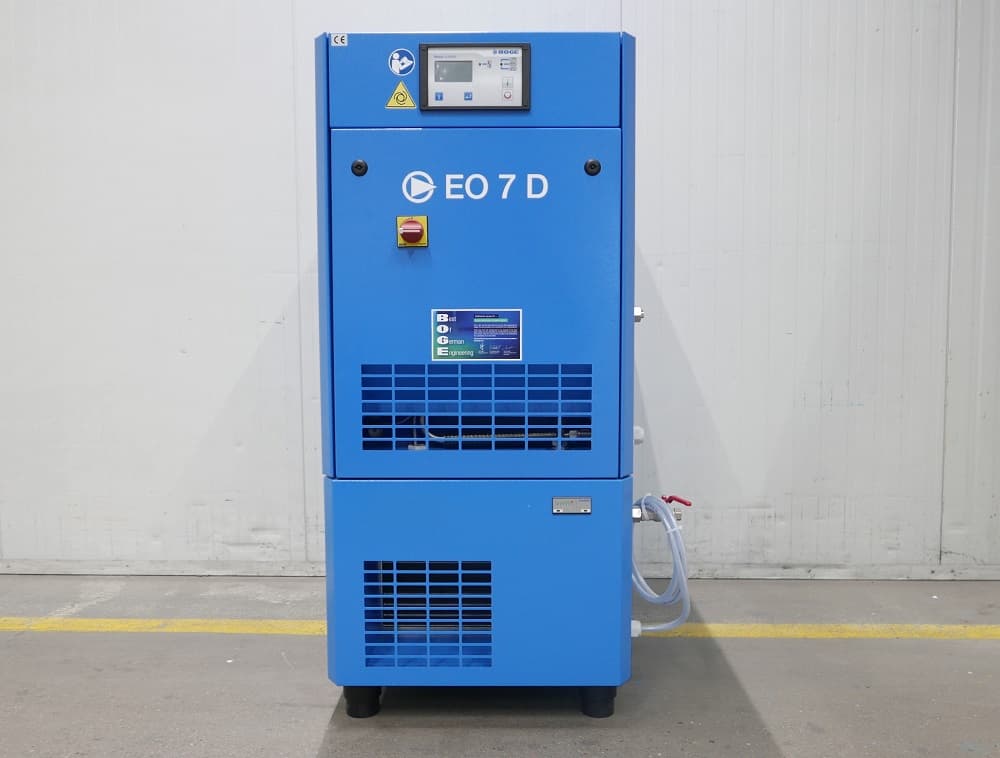 Blue industrial air compressor unit labeled "EO 7 D" with control panel, standing against a white wall.