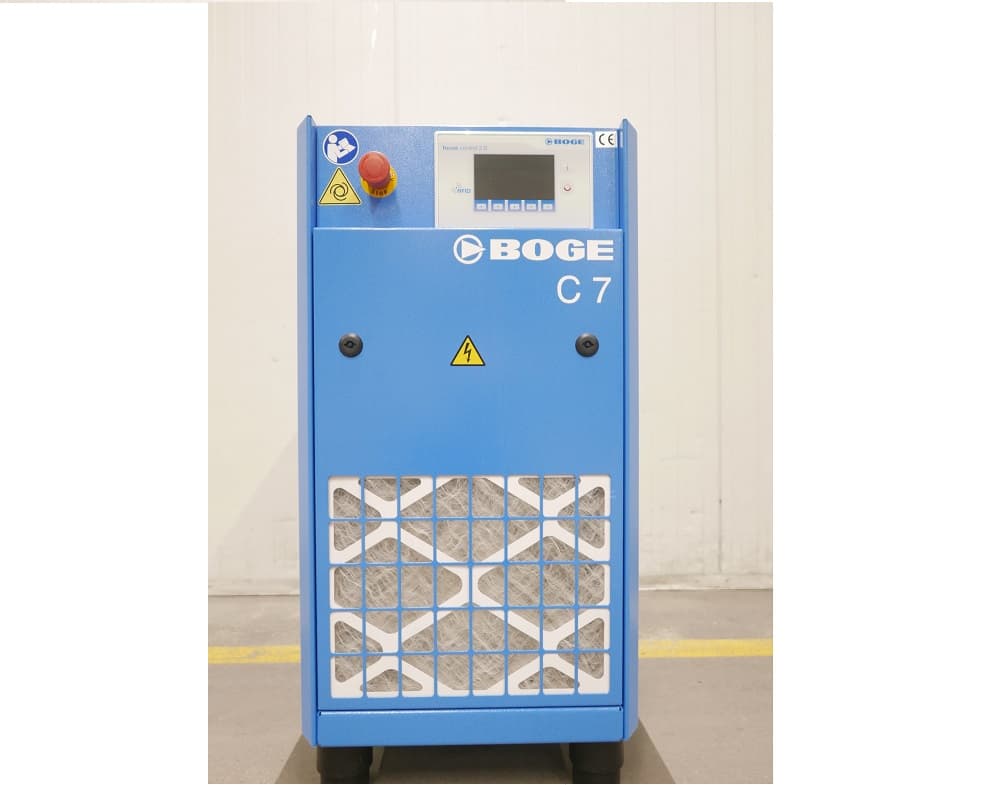 Blue BOGE C7 air compressor with control panel, safety labels, and ventilation grid, standing against a light background.