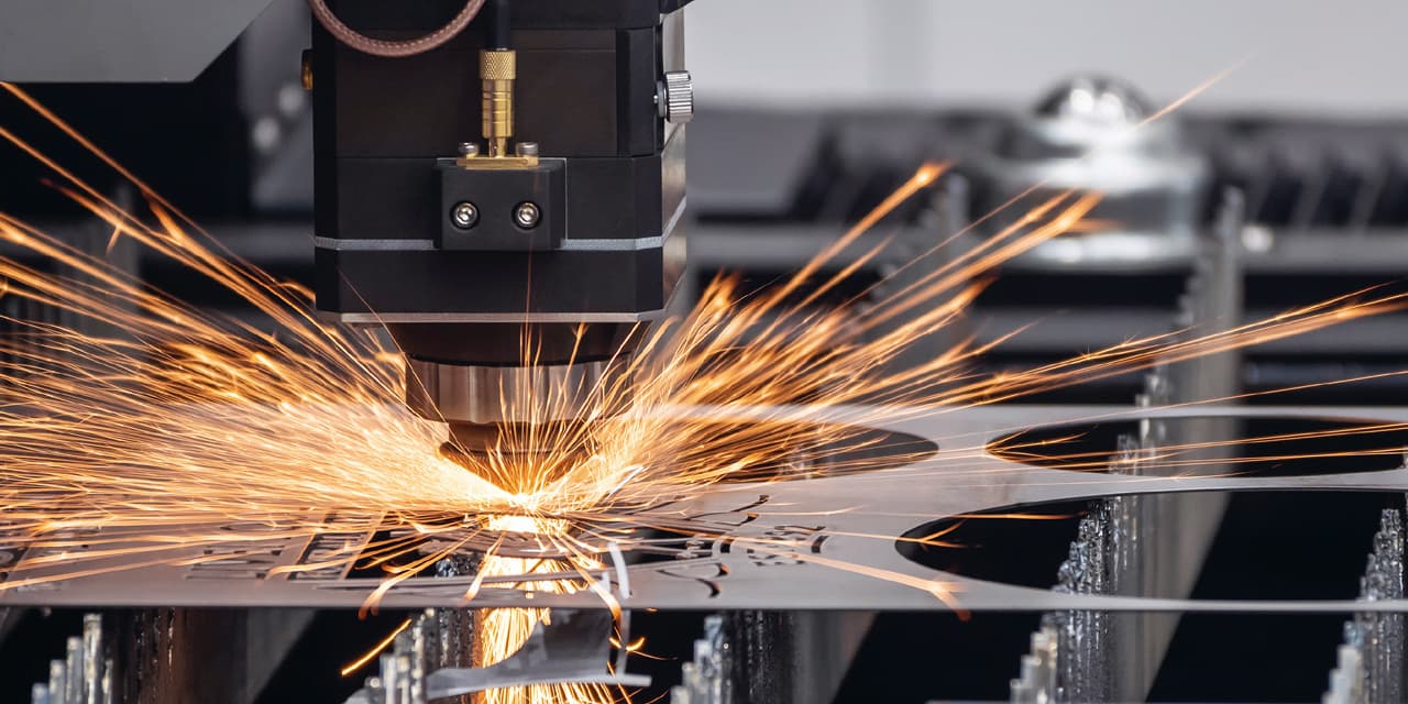 Laserschneider in der Metallverarbeitung sprueht Funken