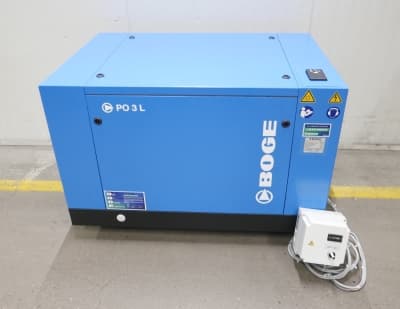 Blue BOGE air compressor unit with control panel, placed indoors on a concrete floor.