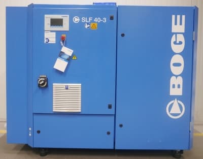 BOGE SLF 40-3 air compressor in blue, featuring a control panel and safety labels, designed for efficient compressed air solutions.