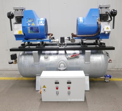 BOGE air compressor system with dual blue units on a silver receiver, featuring control panel and safety labels.