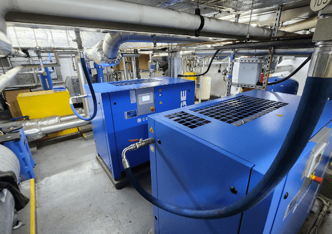 Multiple blue BOGE compressors installed in the engine room onboard Queen Mary 2