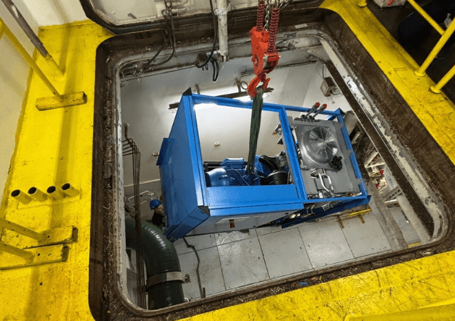 Partially dismantled BOGE compressor being lowered through a hatchway onboard Queen Mary 2